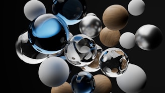 A collection of various spheres, including glass, wooden, and metallic textures, arranged in a dynamic floating composition against a dark background. The spheres reflect and refract light, creating an intricate interplay of shadows and highlights.