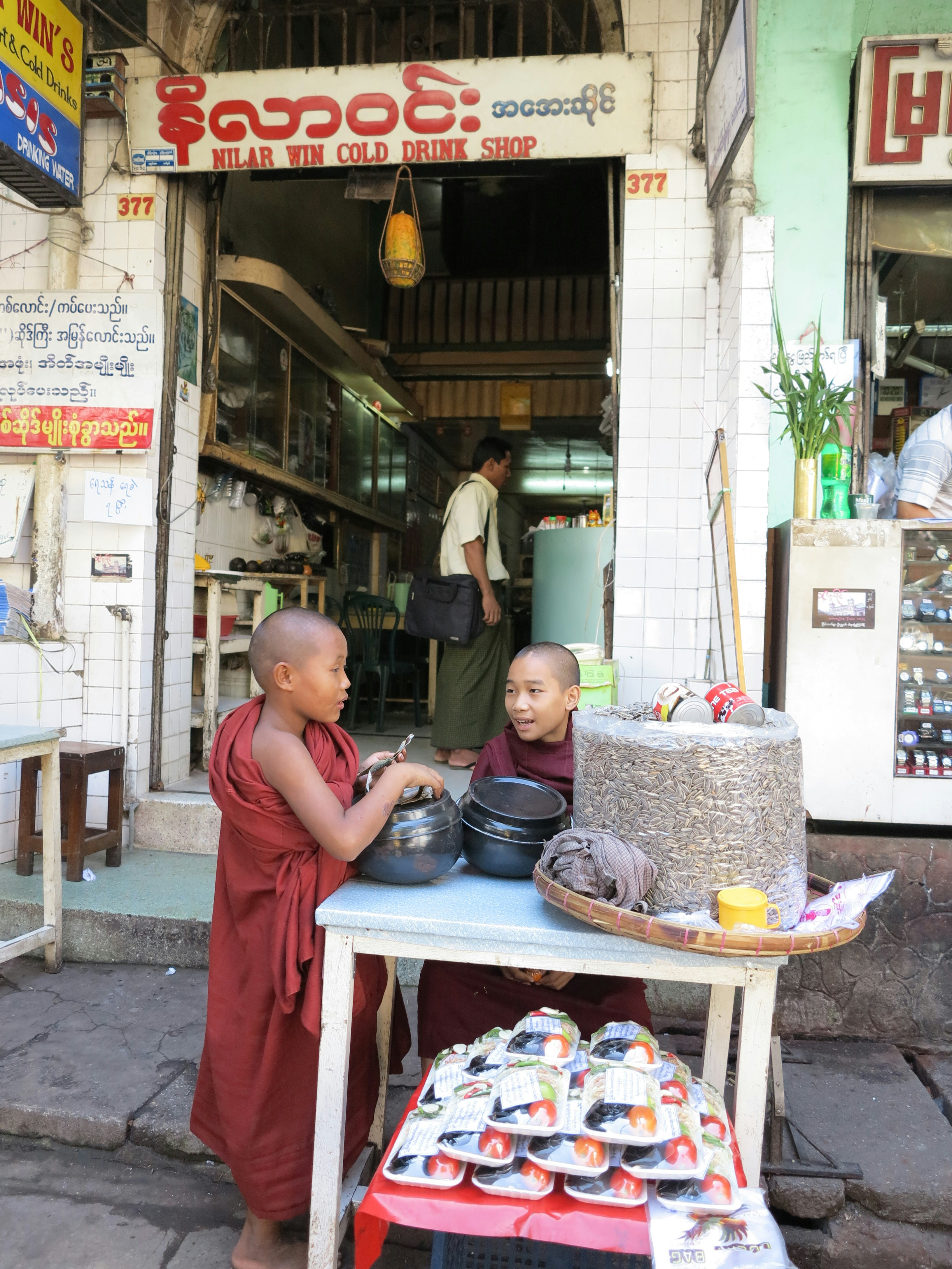 a woman cooking outside of a shop