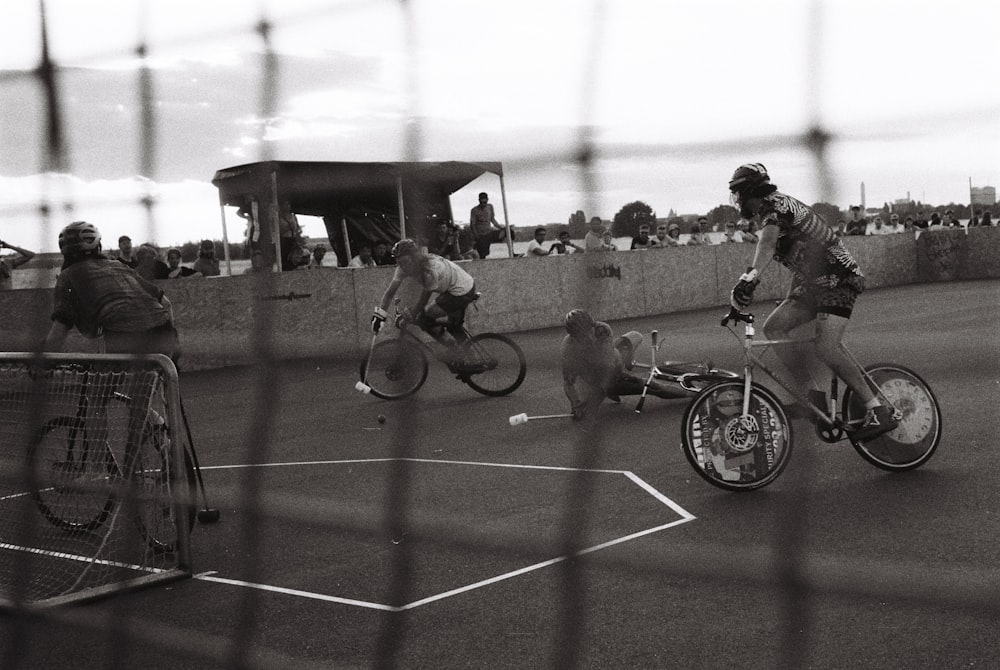 a group of people riding bikes with dogs on the ground