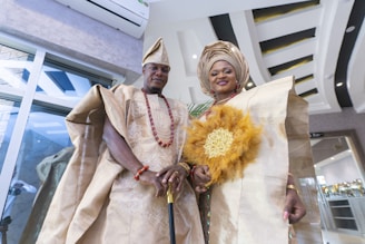 a man and woman wearing traditional clothing