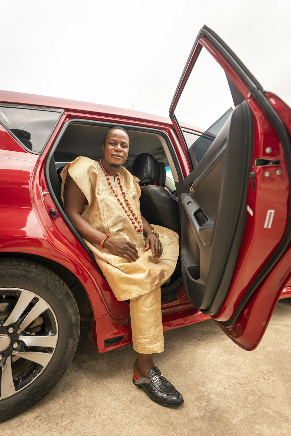 a person in a dress standing in a car