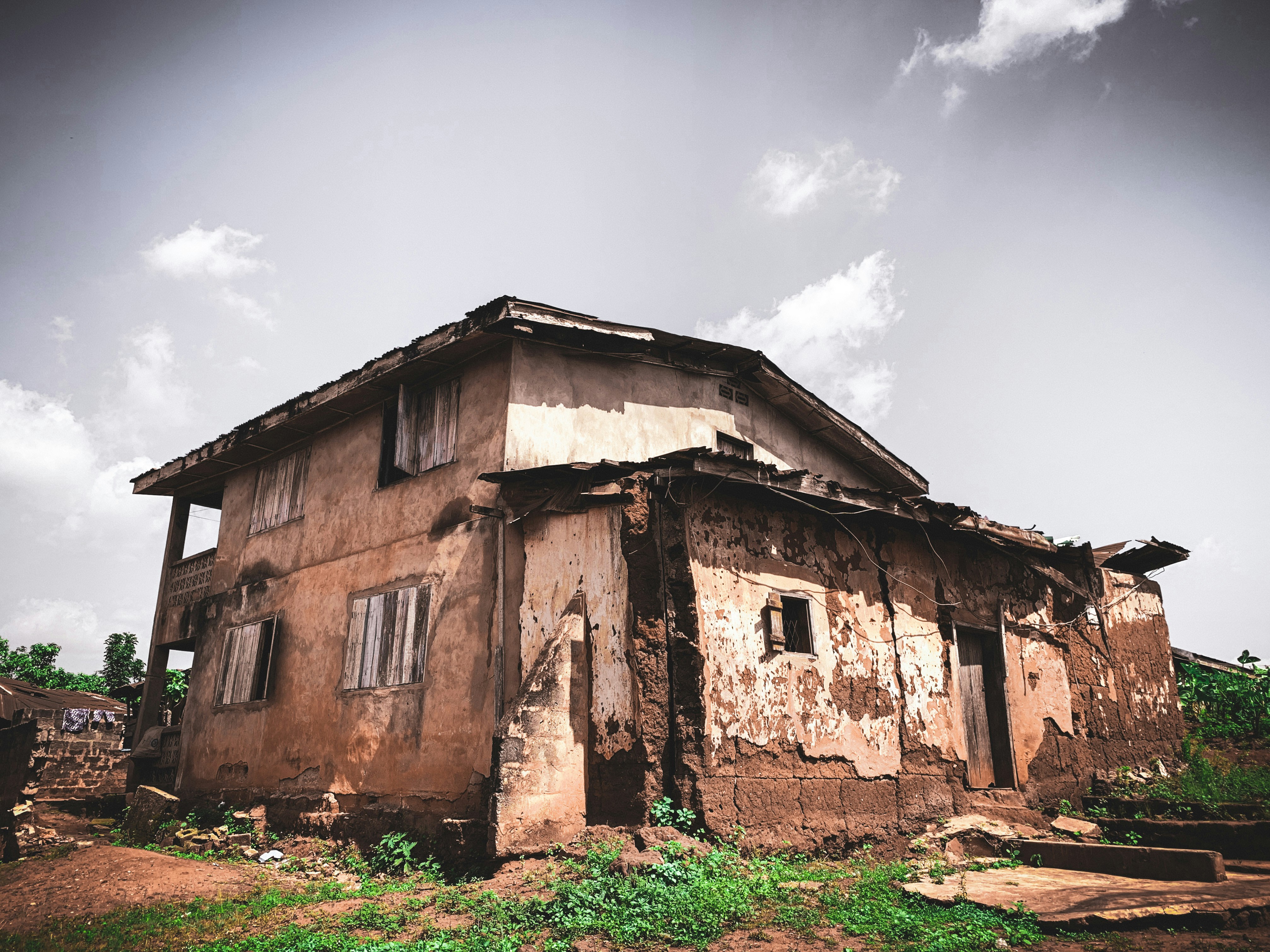 A dilapidated house in a field