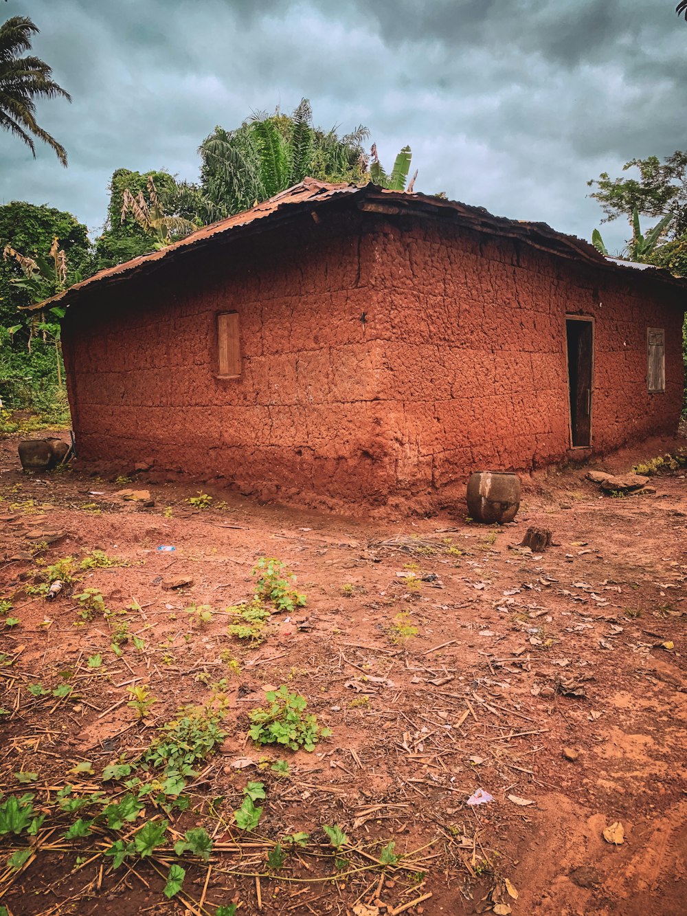 a brick building with a dirt yard