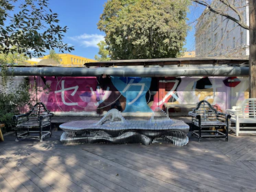 Public seating area featuring colorful, hand-painted benches reflecting Mexican folk art.
