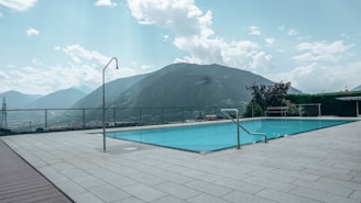 a pool with a mountain in the background