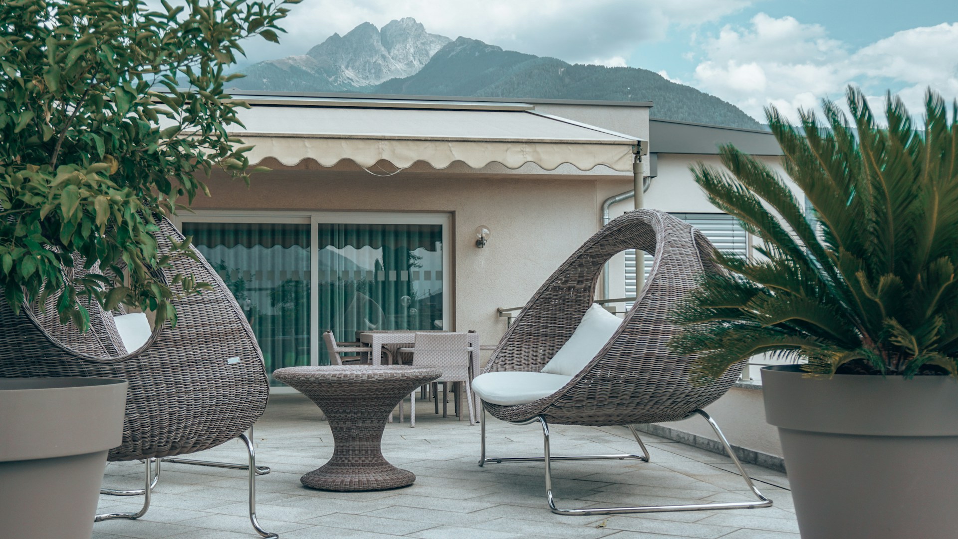 a patio with chairs and a table