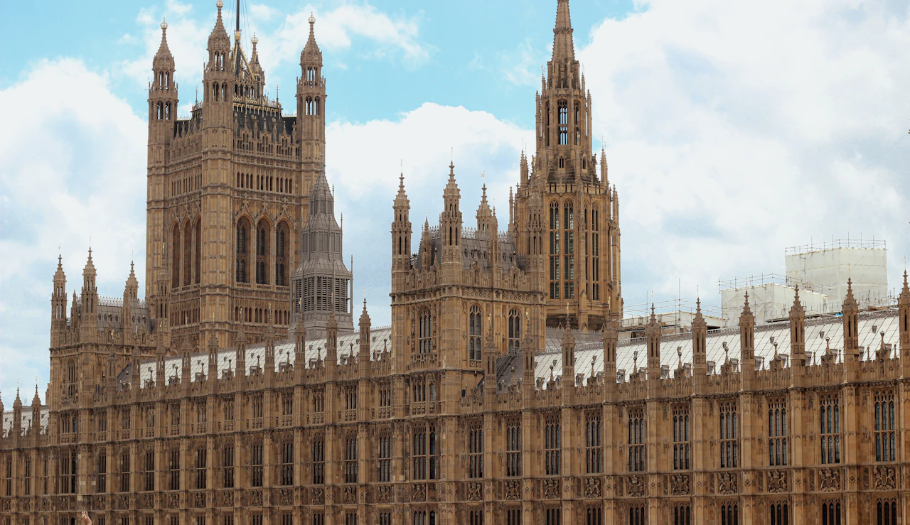 A large building with towers, with the Palace of Westminster in the background
