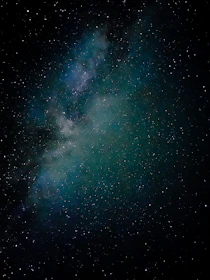 A star cluster twinkling brightly, scattered across the velvet blackness of space.