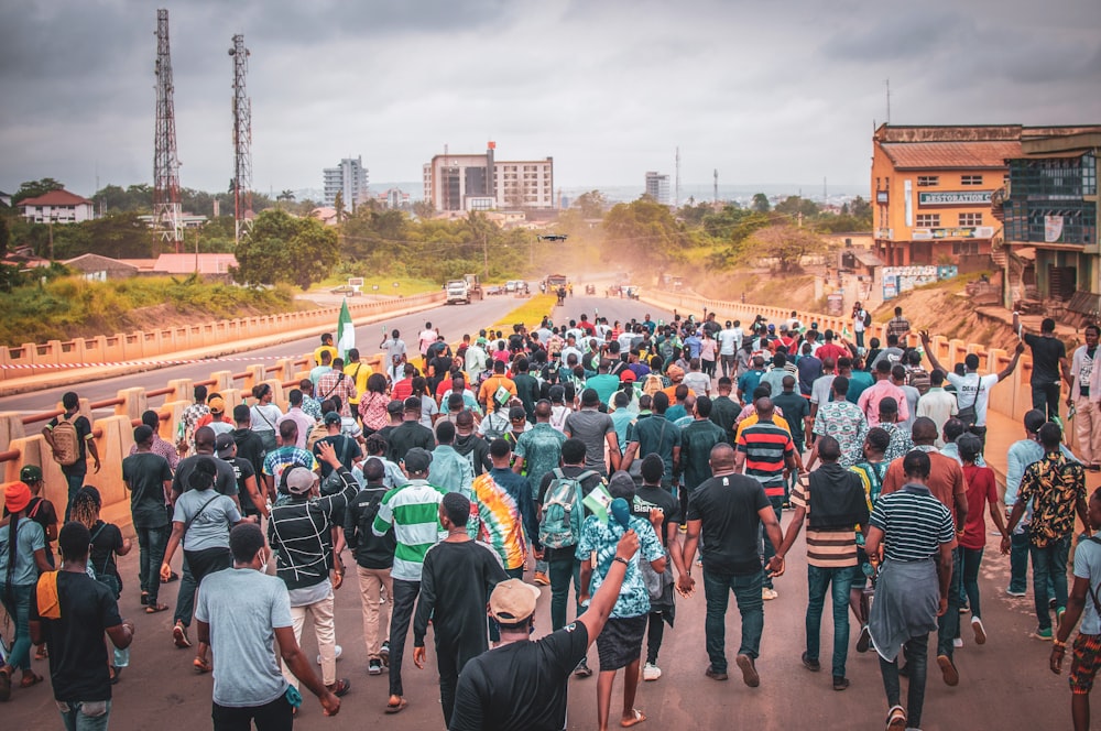 a large group of people walking on a street