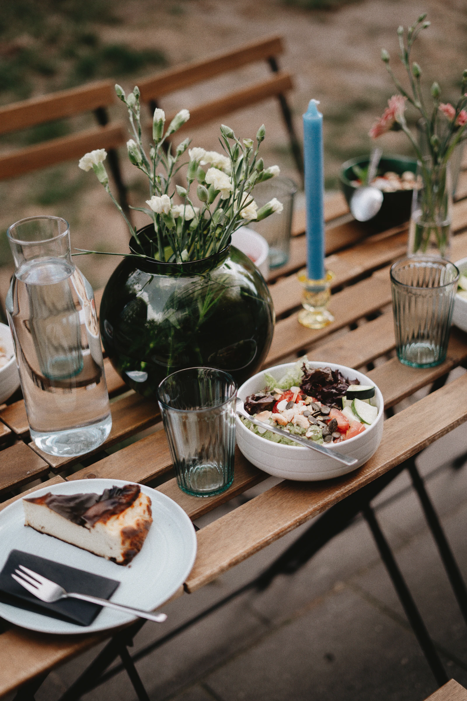 Real dining table with clear drinking glasses and tableware