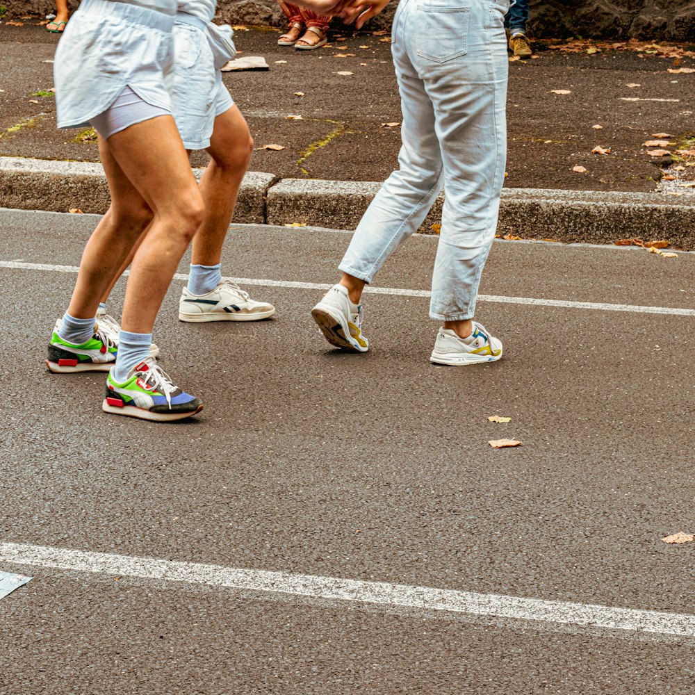 a pair of people walking on a street