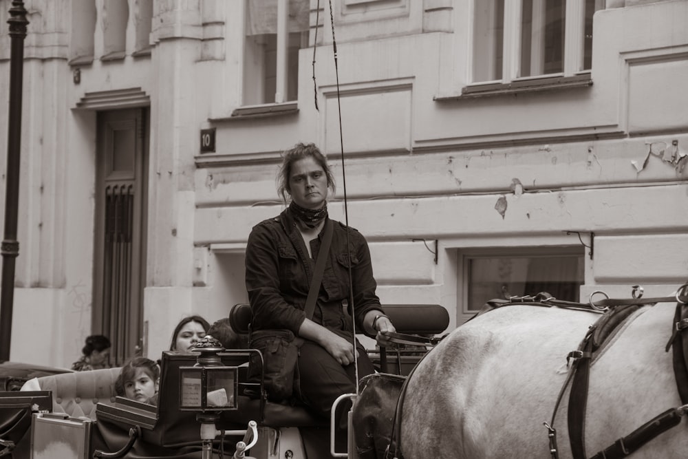 a man riding a horse carriage