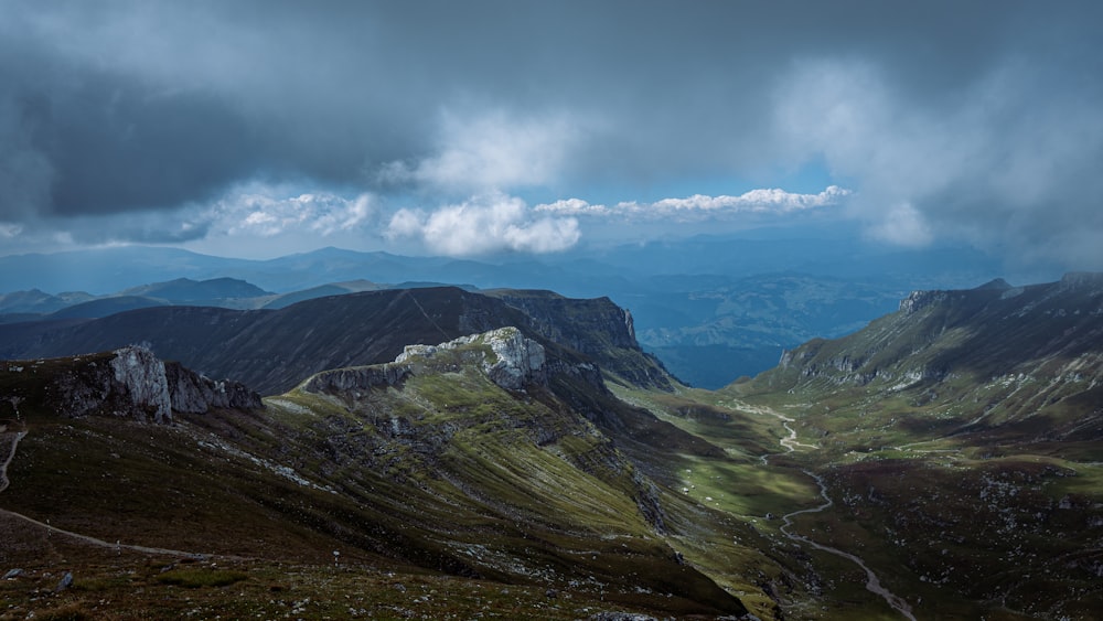 a landscape with mountains and clouds