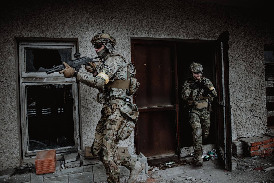 a couple of soldiers in a doorway, Airsoft players outside of the building with their Arcturus AT-PP19-1 ME Vityaz replicas.