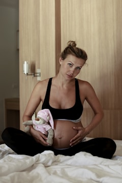 Woman doing gentle abdominal exercises at home with a calm expression.