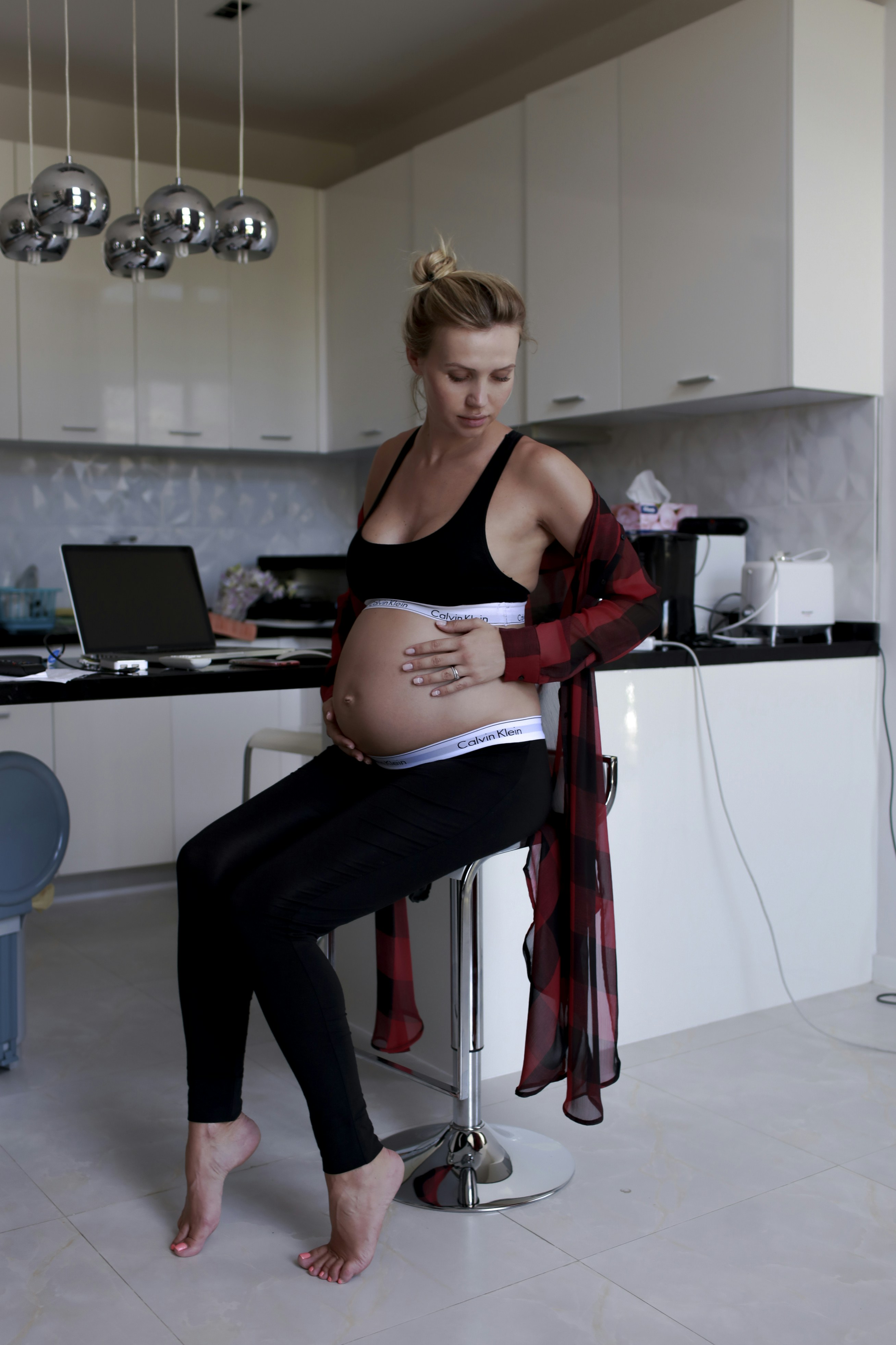 Pregnant woman planning finances and writing a budget