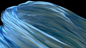 Flowing abstract design featuring smooth, wavy forms reminiscent of fabric or liquid. The surface has a glossy texture with shades of blue and green.