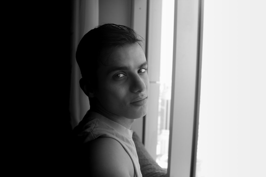 a man looking out a window,