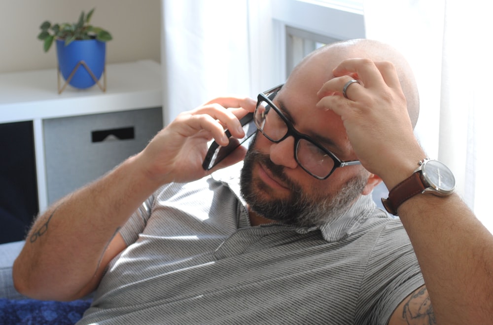 a man with glasses and a watch