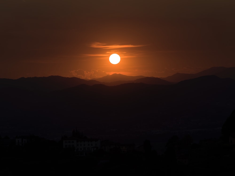 a sunset over a mountain range