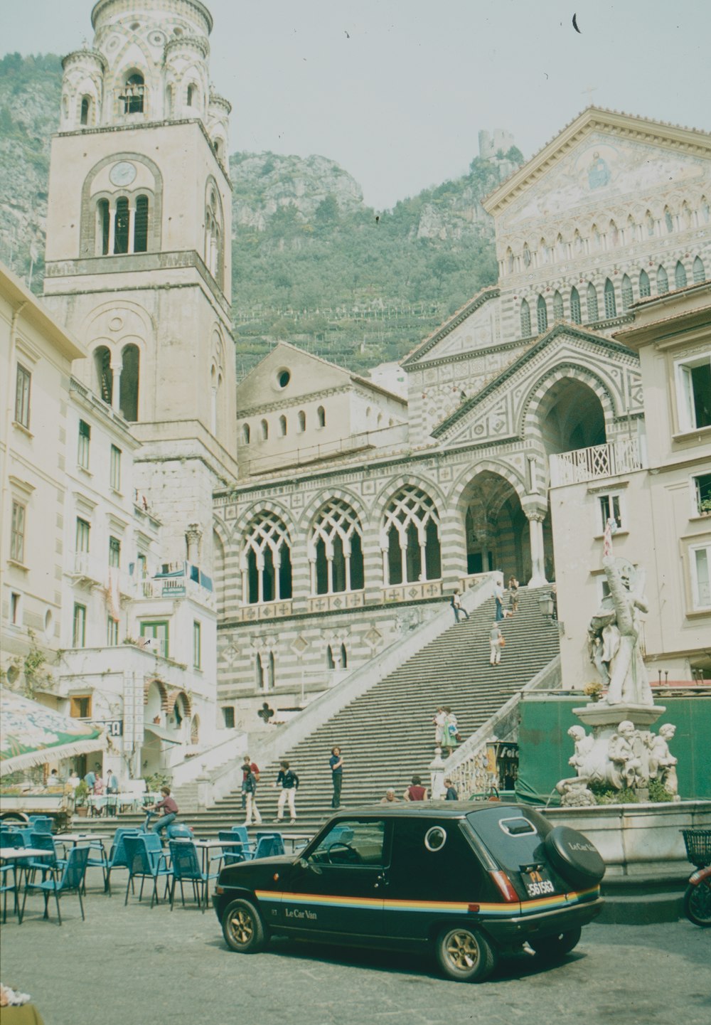 a car parked in front of a building with a staircase