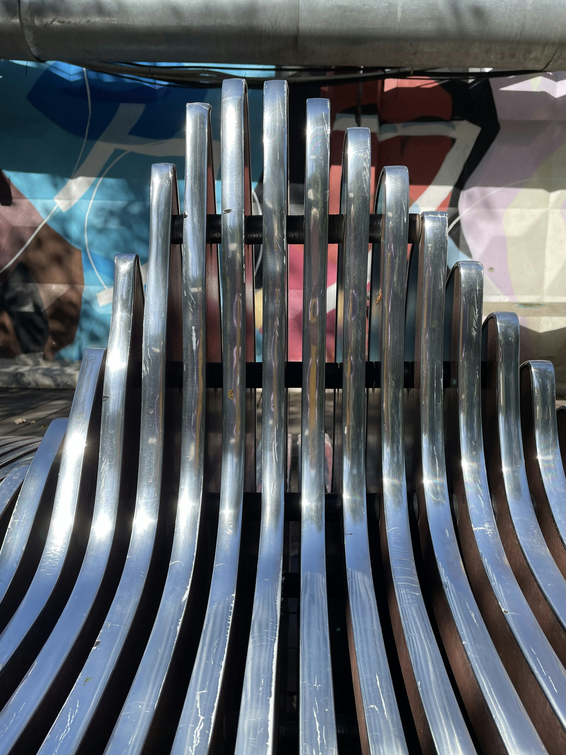 a metal fence with a metal bar