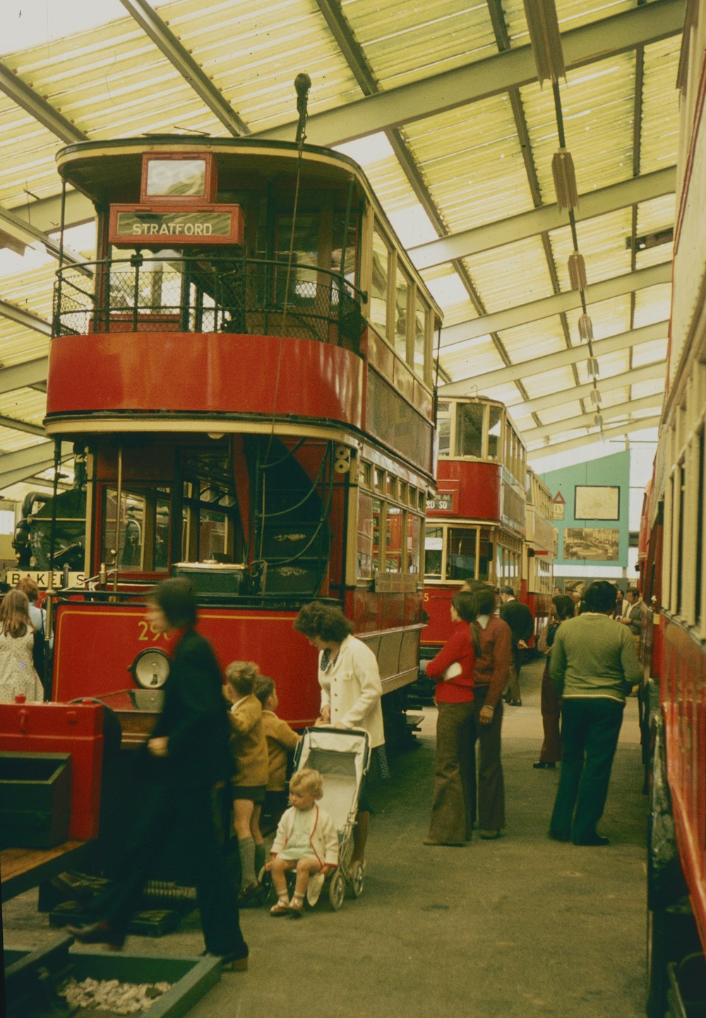 a group of people standing next to a bus