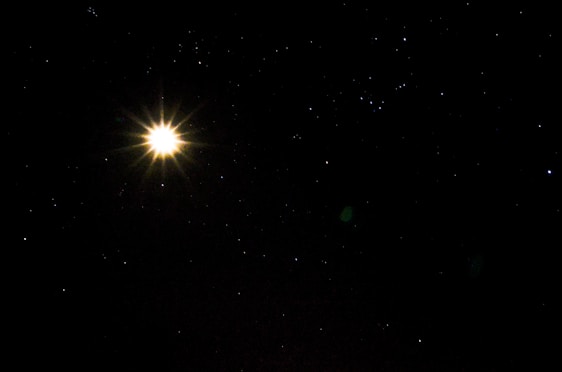 A glowing star shining brightly over a dark horizon, symbolizing guidance and new beginnings.