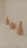 Three ceramic vases are arranged in a row on a plain light background. Each vase has a different shape, featuring smooth curves and a matte finish.