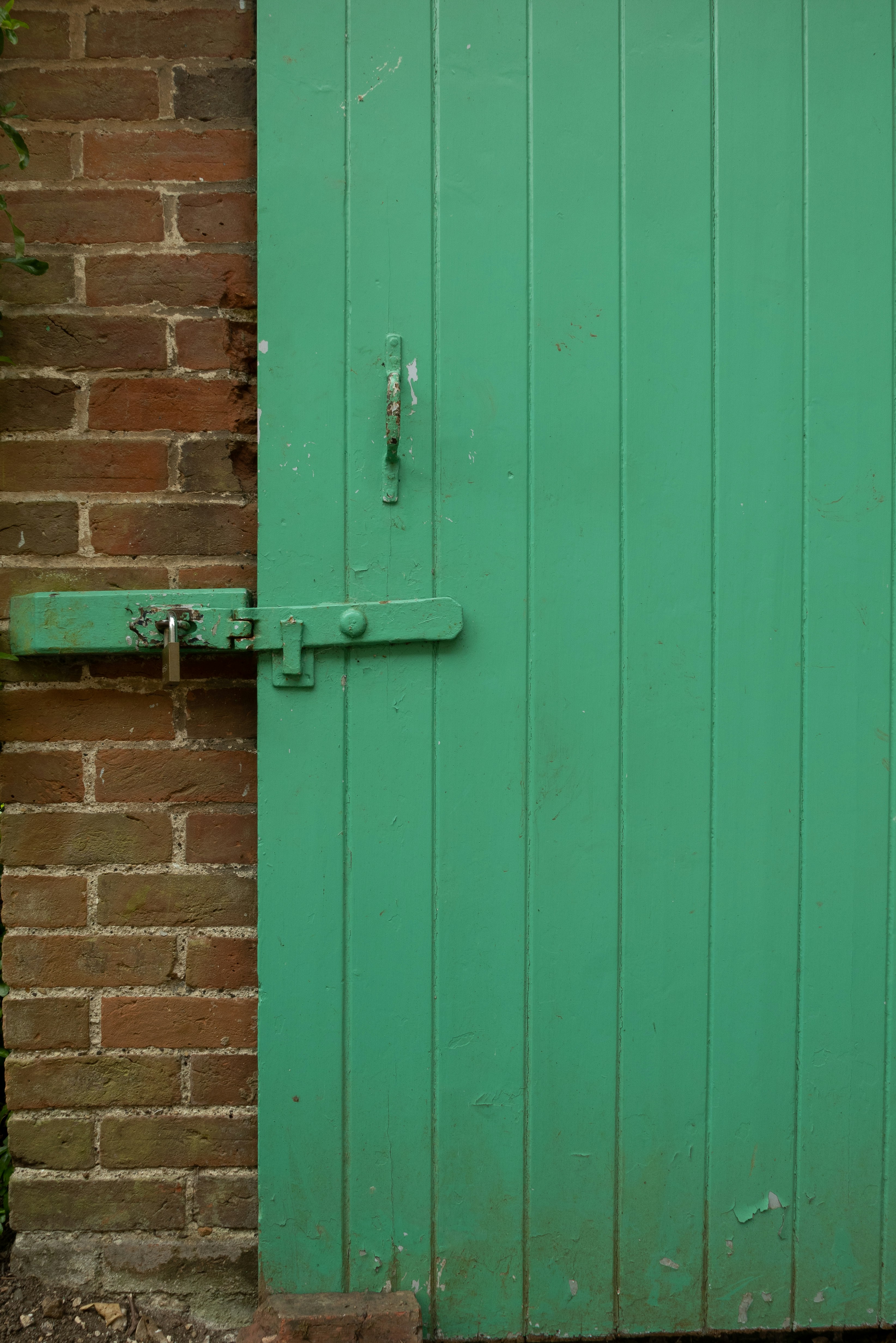 a green door with a metal handle