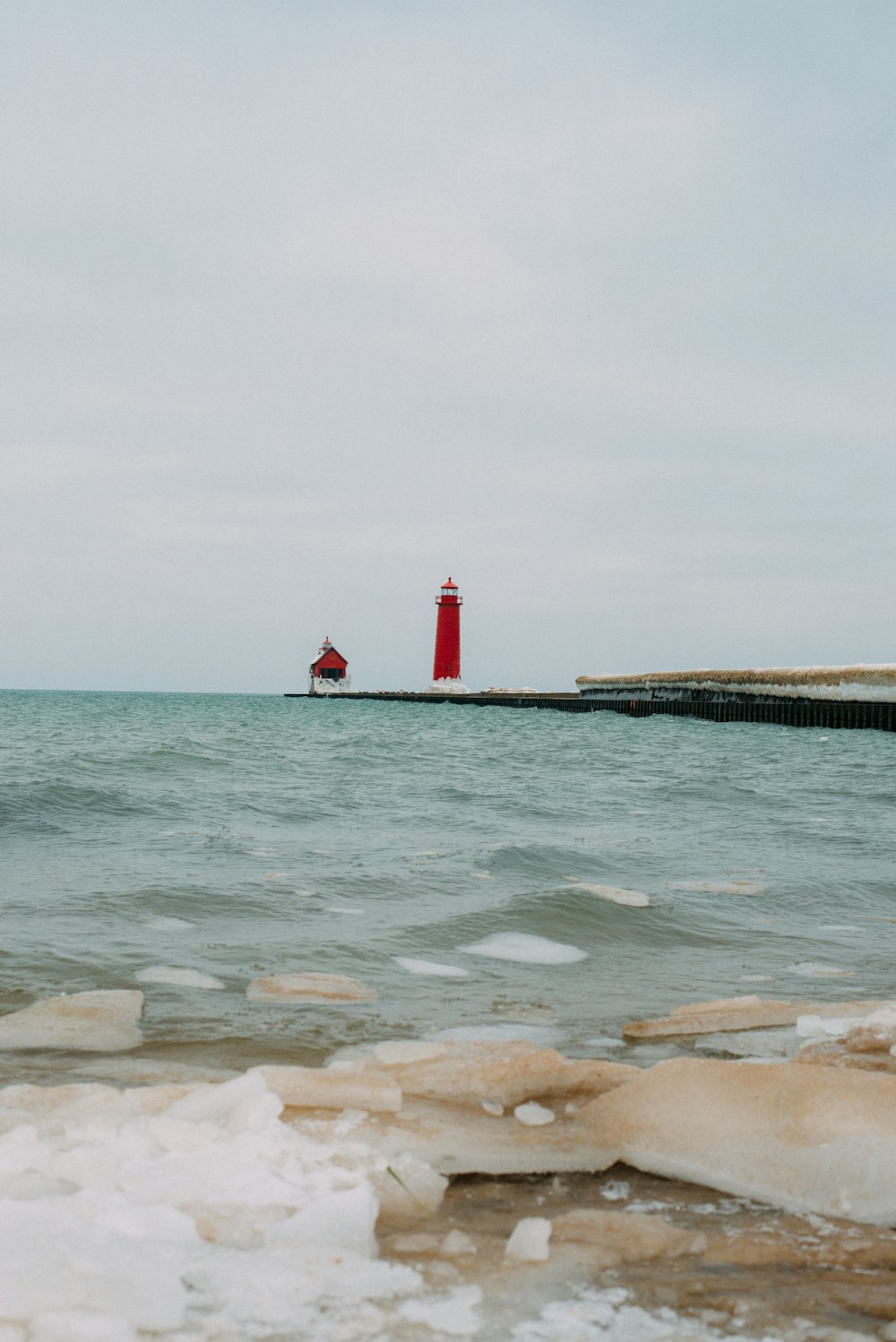 a red light house on a pier