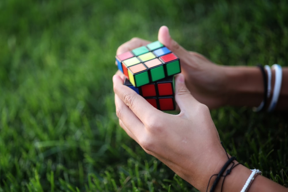 a person holding a cube