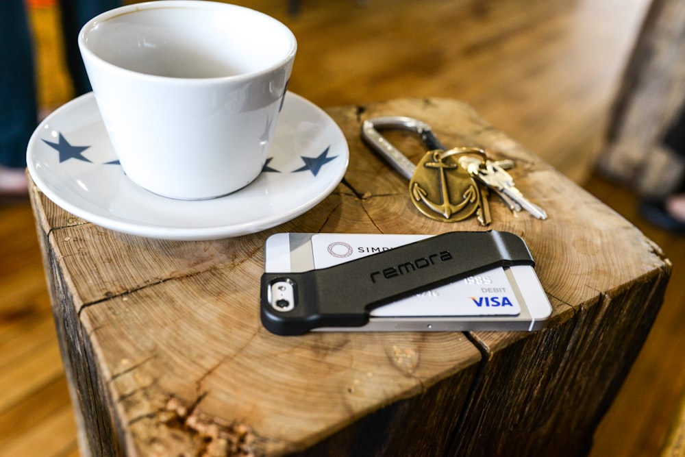 a key chain and a cup of coffee on a table