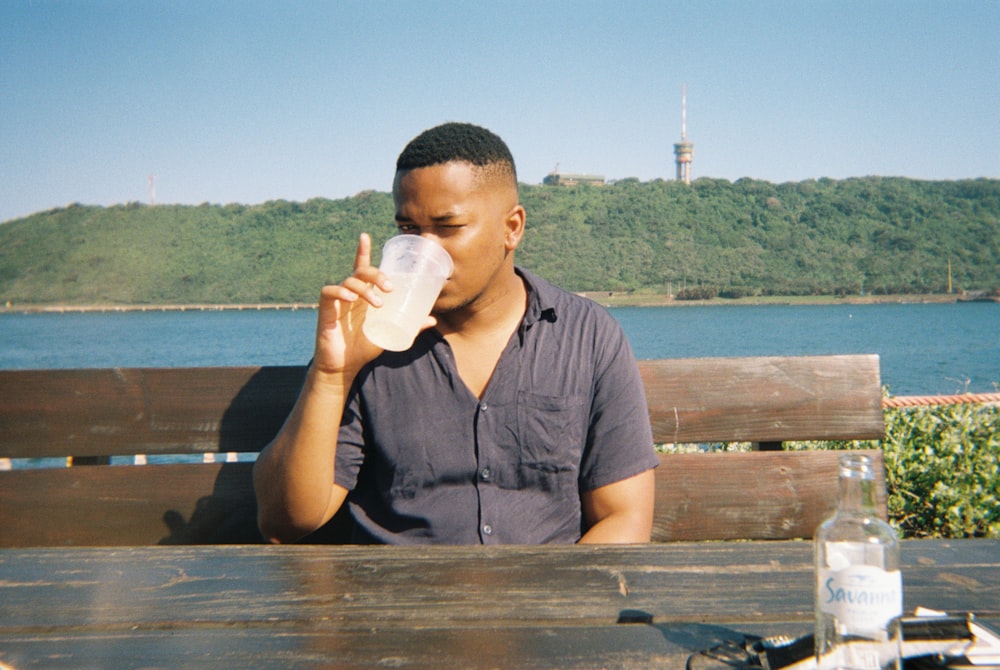 a man drinking from a glass