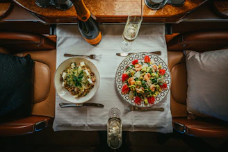 a table with plates of food and glasses on it