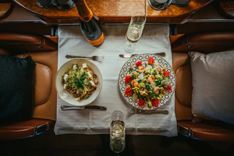 a table with plates of food and glasses on it