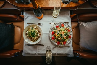 a table with plates of food and glasses on it