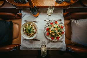 a table with plates of food and glasses on it