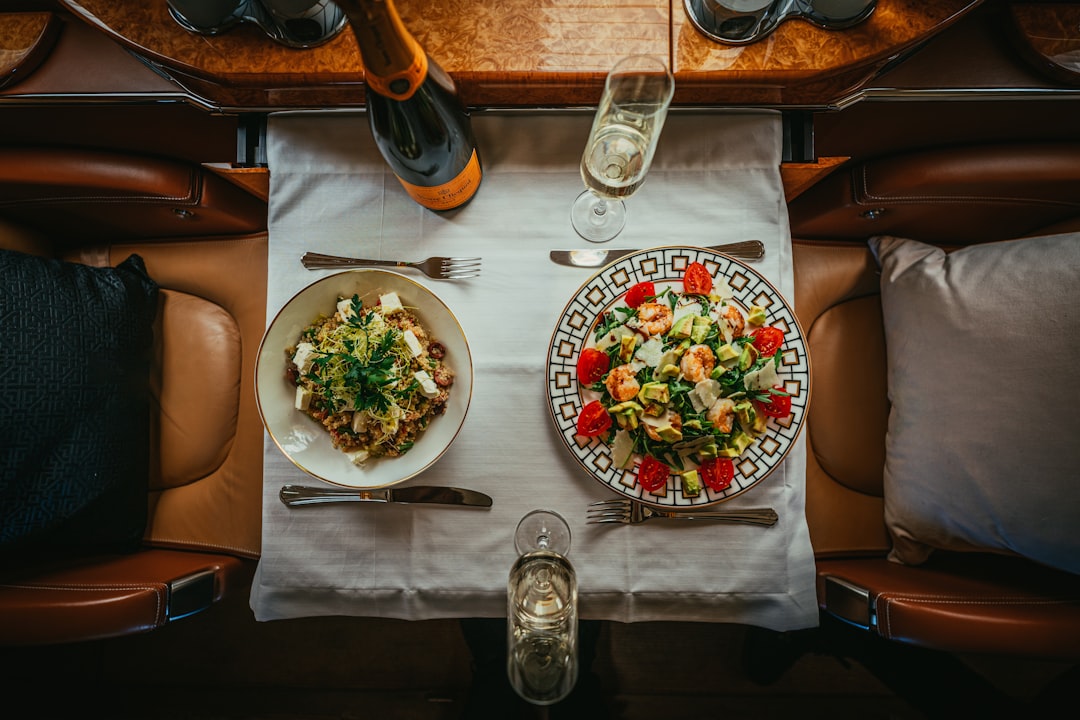 a table with plates of food and glasses on it,