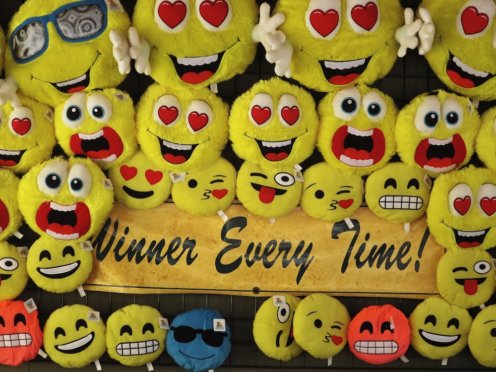 a group of yellow and blue cupcakes with faces on them