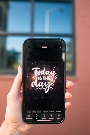 a hand holding a cell phone