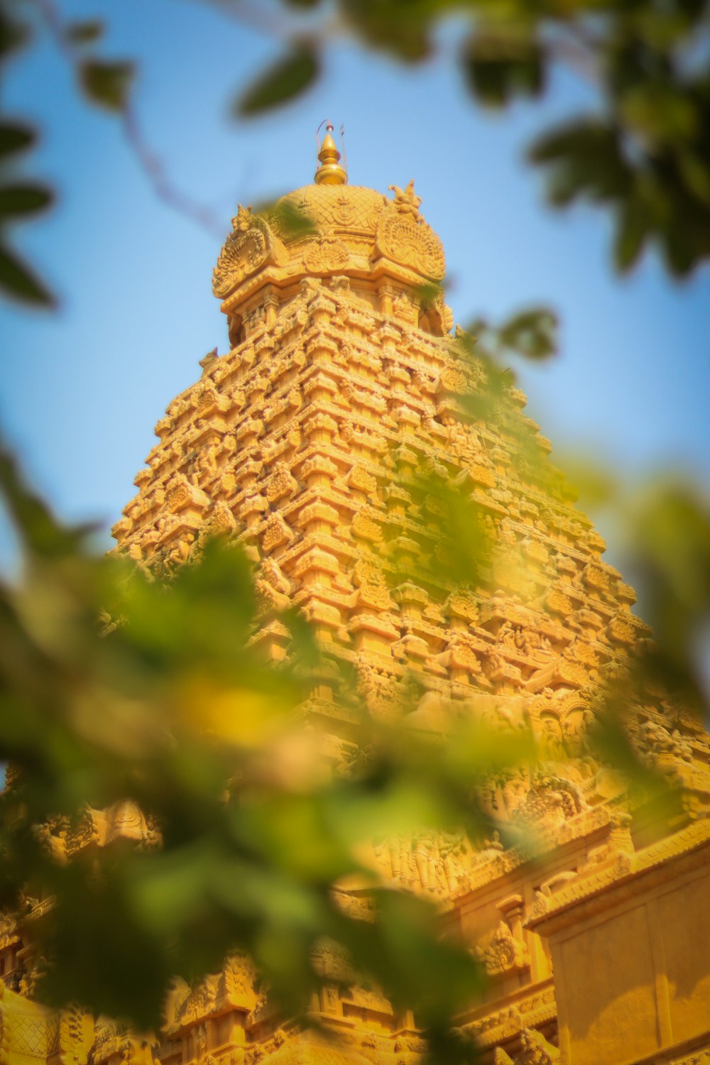 a stone tower with a gold top