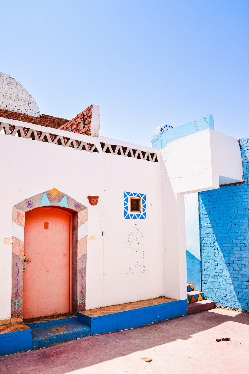 a white building with a red door