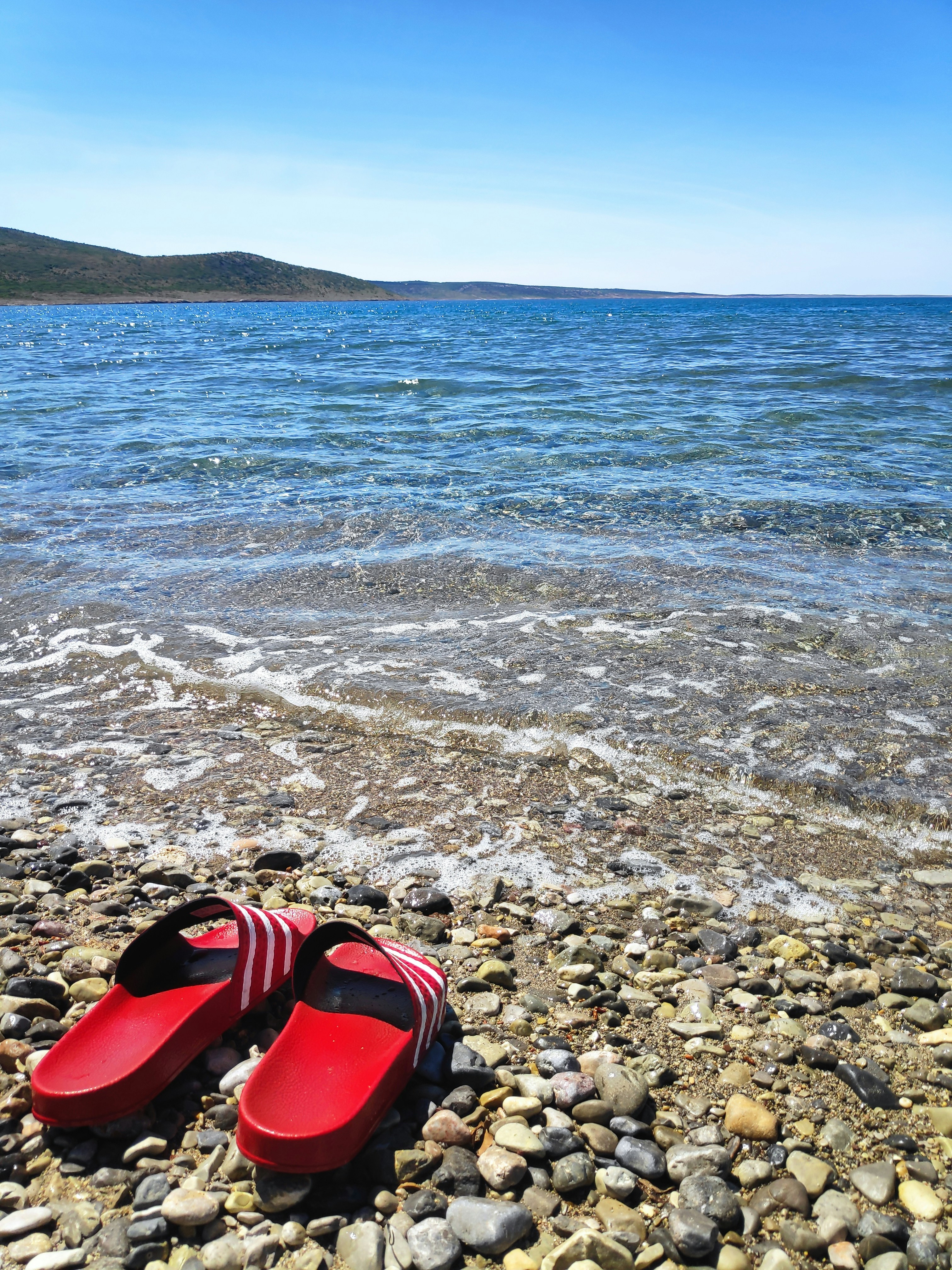 a red shoe on a rocky beach