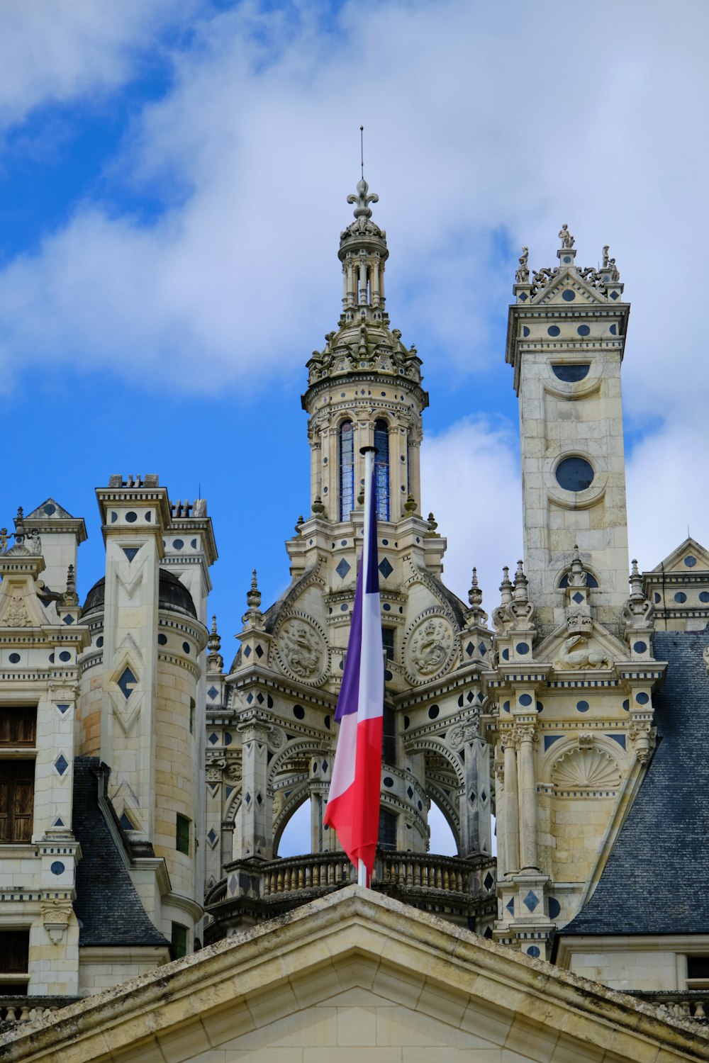 a large building with towers and a flag on top