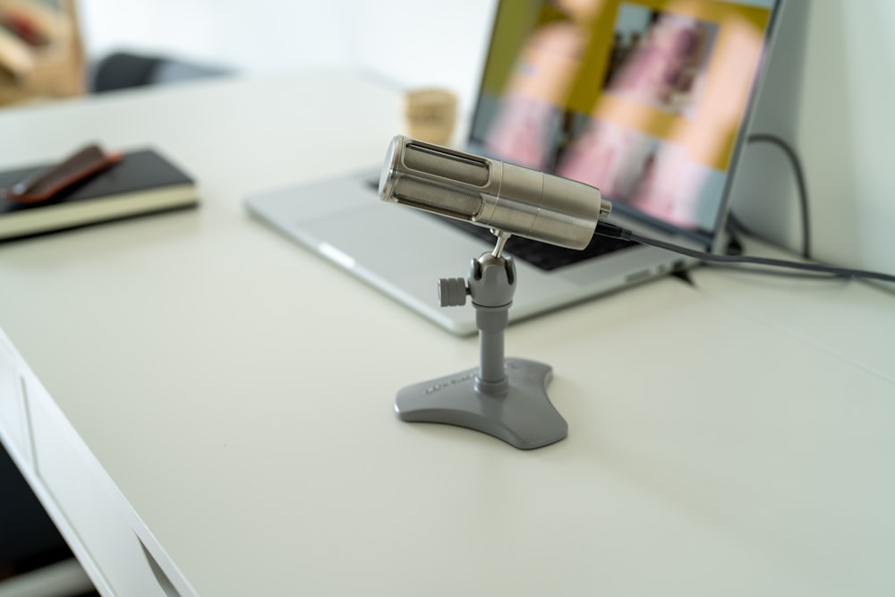 a silver and black stapler on a white surface