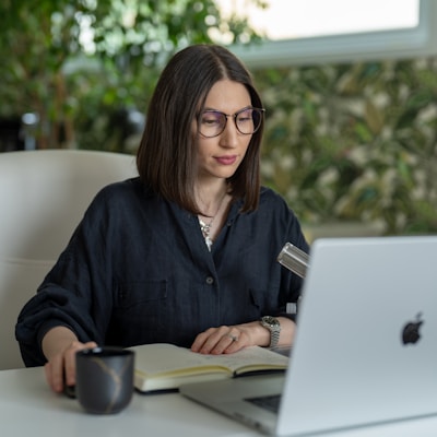 a person sitting at a table with a laptop