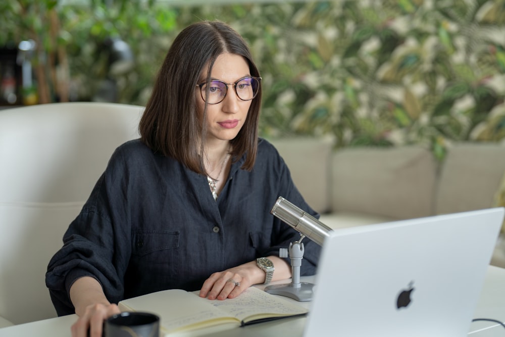 a person sitting at a table with a laptop