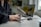 Close-up of a professional man using a headset in a bright workspace.