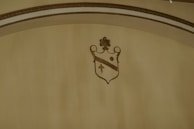 Close-up of the fleur de lis emblem embroidered on a ceremonial sash.